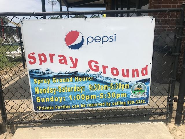 Image of a plastic hanging sign with the Pepsi logo and Spray Ground in red