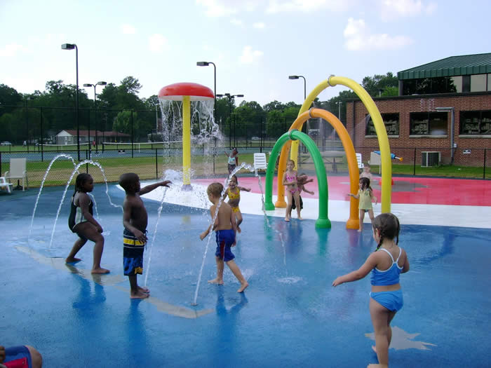 Children playing in the splash pad water features